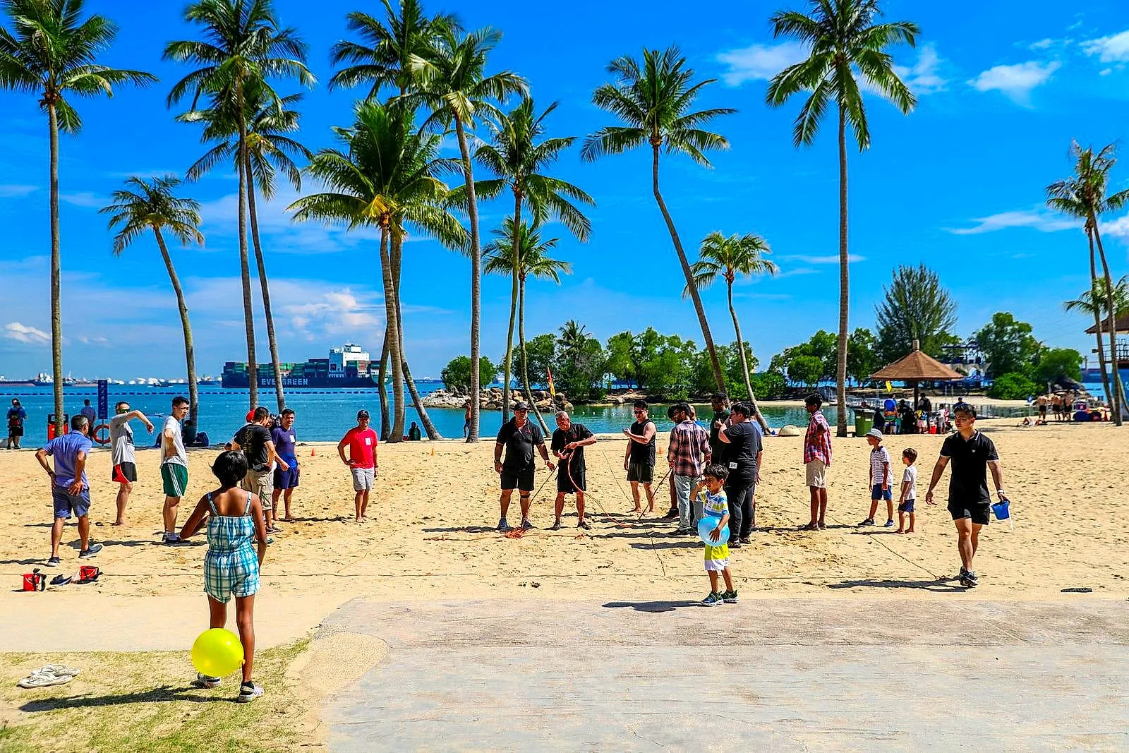 Families playing games on a sunny island beach