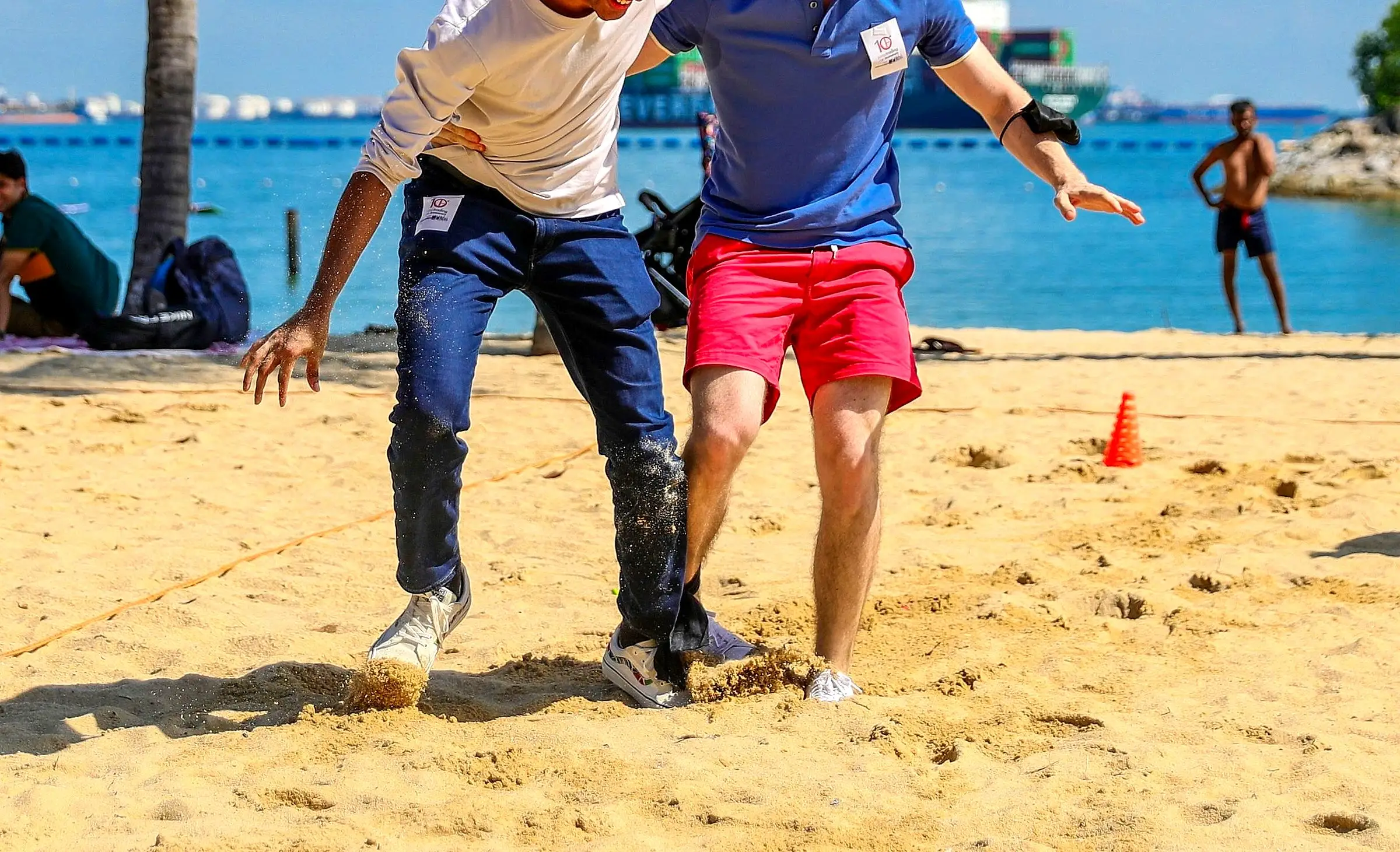 Two adults competing in a beach race