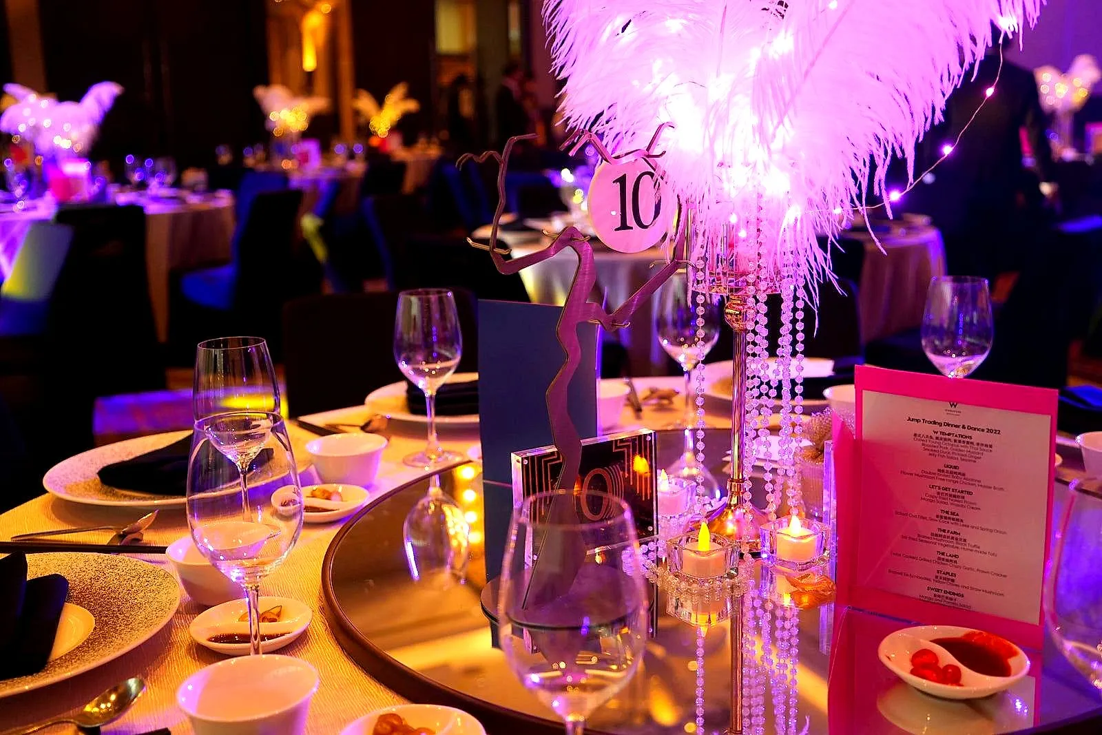 Crystal and feather centrepiece with a table number and menu card