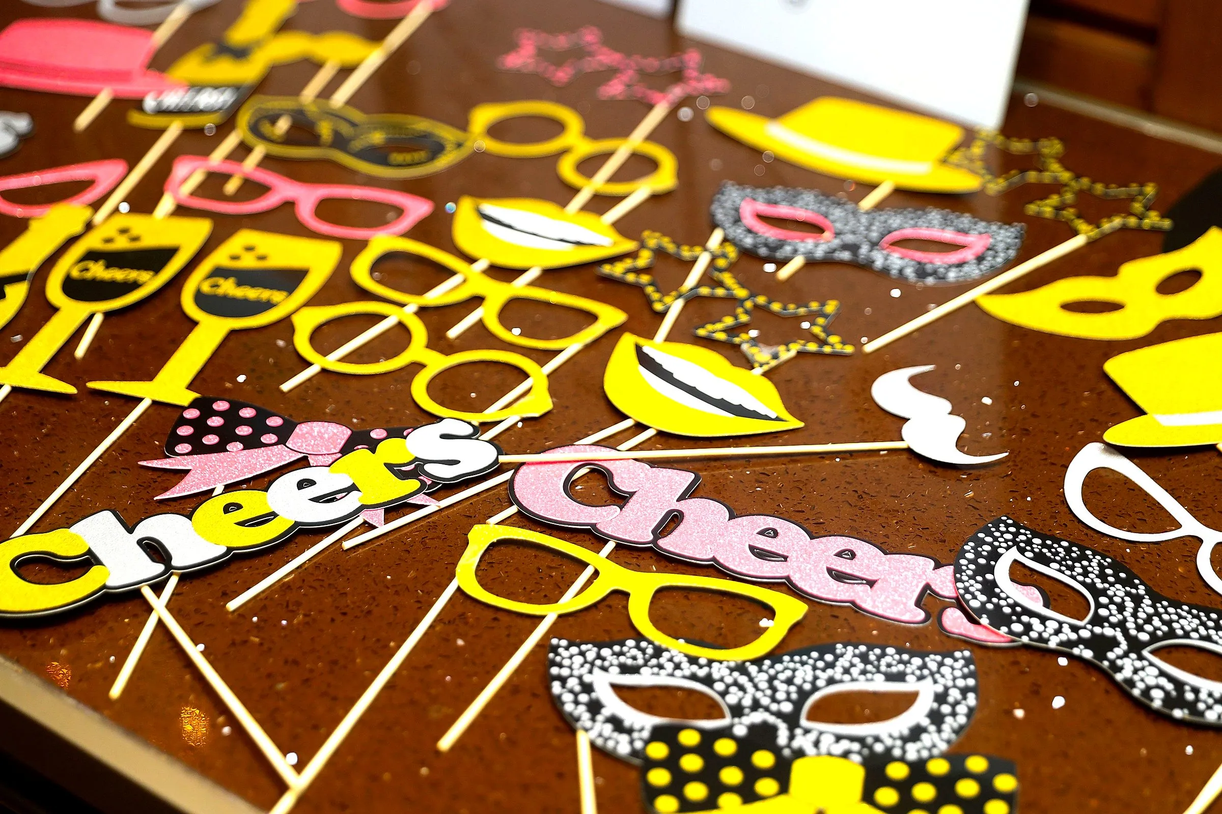 Cheers-themed photo props fanned across a table
