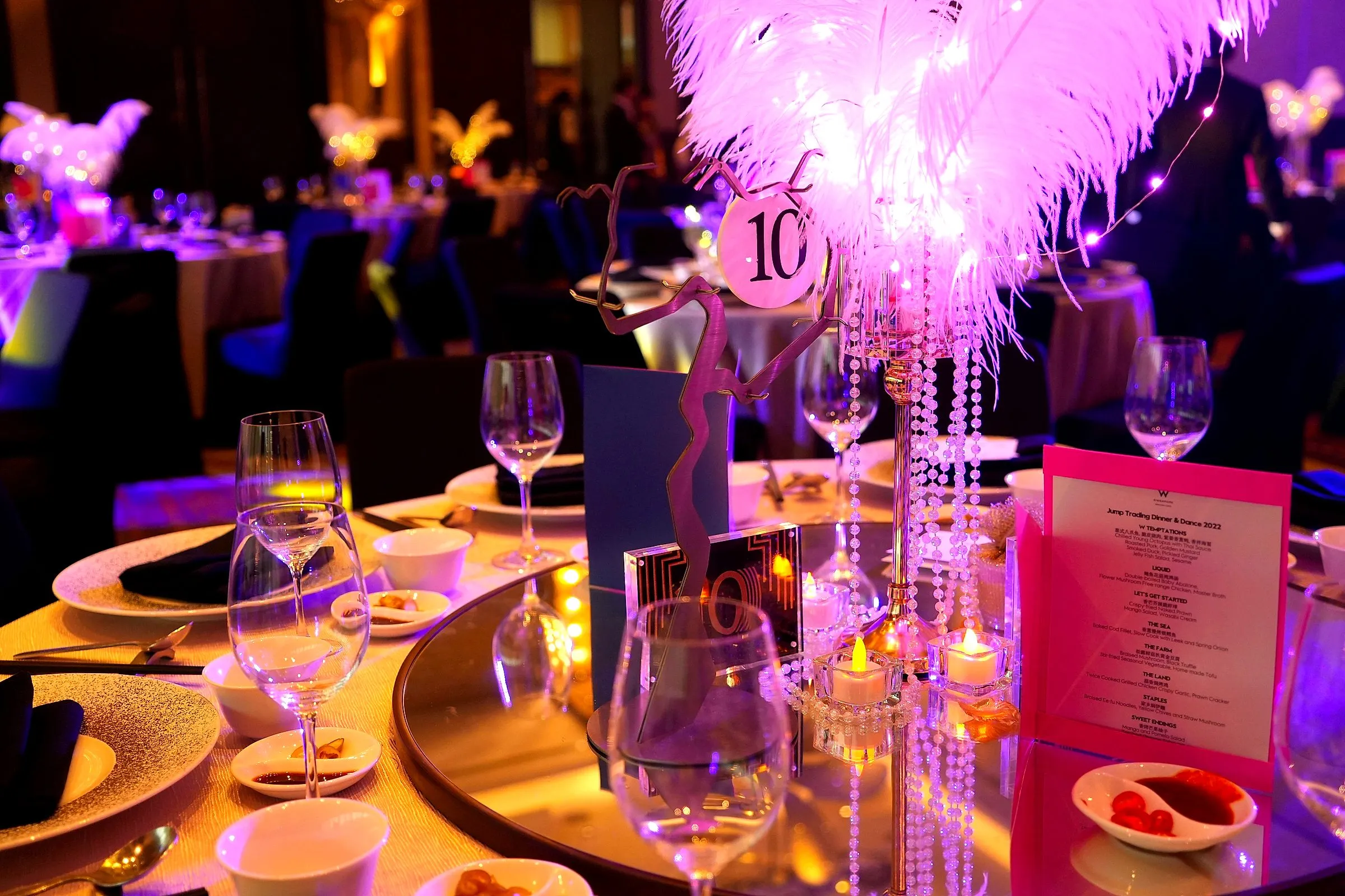 Feather and crystal table centrepiece beside a place setting