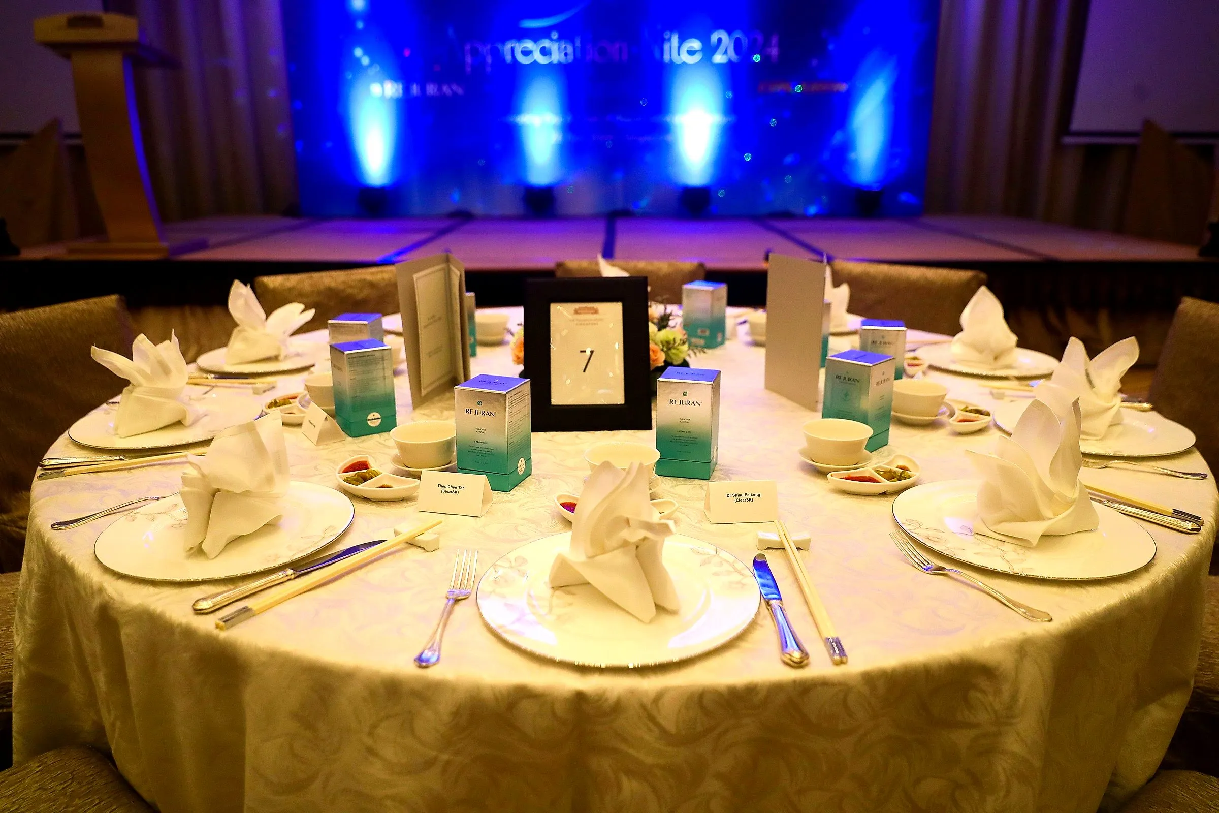 Elegant table setting lit by blue stage lights